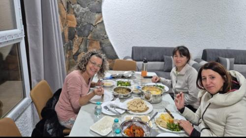 a group of women sitting at a table eating food at Climbing Guest House Jebel Shams in Dār Sawdāʼ