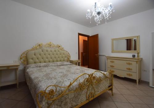 a bedroom with a bed and a dresser and a chandelier at Casa DiVa in Terni