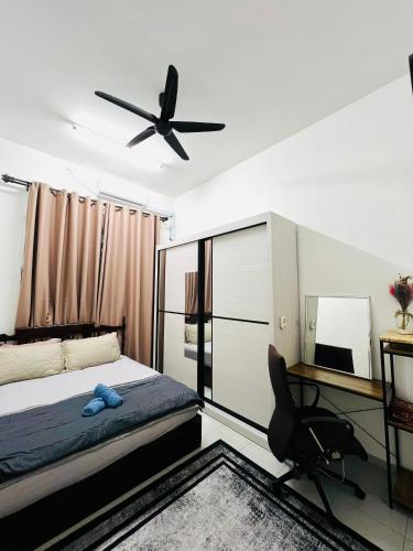 a bedroom with a bed and a ceiling fan at Inap Indah in Kuantan