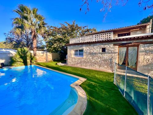 a swimming pool in front of a house at Lacosse in Le Grau-dʼAgde