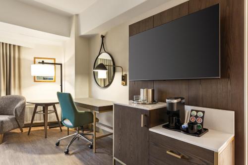 a hotel room with a desk and a tv at Crowne Plaza Seattle - No Resort Fee - Newly Renovated IHG Hotel in Seattle