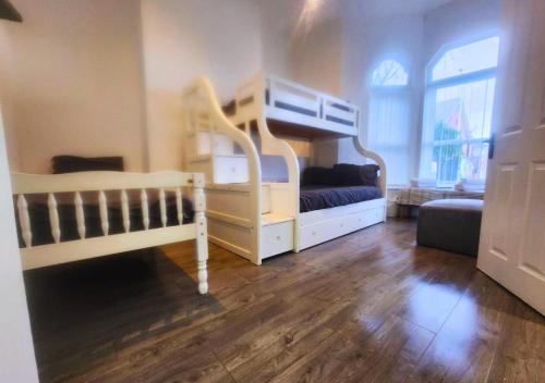 a bedroom with a bunk bed and a crib at Kop View in Liverpool
