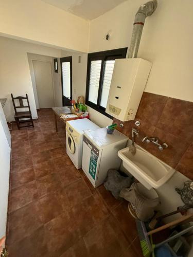 a kitchen with a sink and a washing machine at Barrio Privado - YB - Tucumán in Yerba Buena