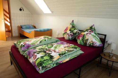 a bedroom with a bed with a colorful bedspread at Ferienwohnung Familie Löffler in Ostrach
