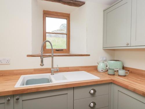 a kitchen with a sink and a window at Howgill Head in Kendal