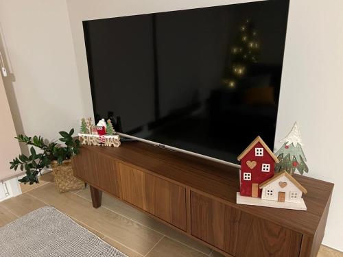 a flat screen tv sitting on top of a entertainment center at Alojamientos Ría de Vigo & Alborada in Moaña