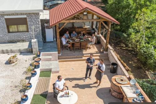a group of people standing on a patio at Villa Jazmín - Piscina - BBQ - Jardín - Chill out in Masía Aldamar
