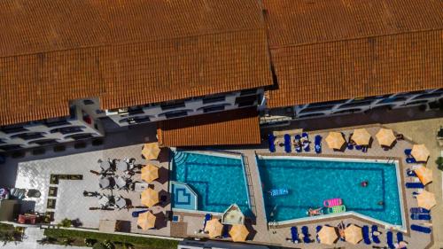 an overhead view of a swimming pool in a building at Vossos Hotel Apartments in Laganas