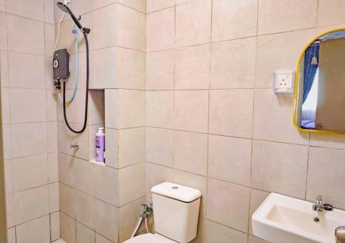 a bathroom with a shower and a toilet and a sink at NonaStudio Myra Park Nilai 3 in Nilai