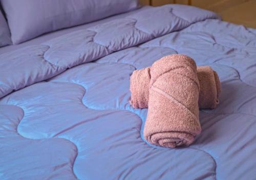 a pair of towels laying on top of a bed at NonaStudio Myra Park Nilai 3 in Nilai