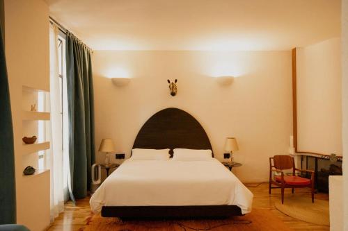 a bedroom with a large white bed in a room at Casa Pani in Mexico City