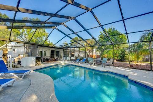 an indoor swimming pool with a glass roof at Dock and Beautiful Views! Spacious Bellows Lake Gem in Tampa
