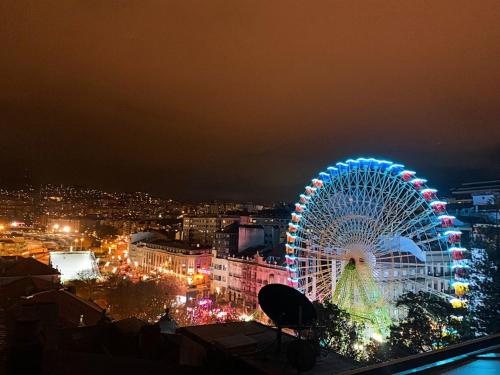 a ferris wheel in a city at night at Alojamientos Ría de Vigo & Alborada in Moaña