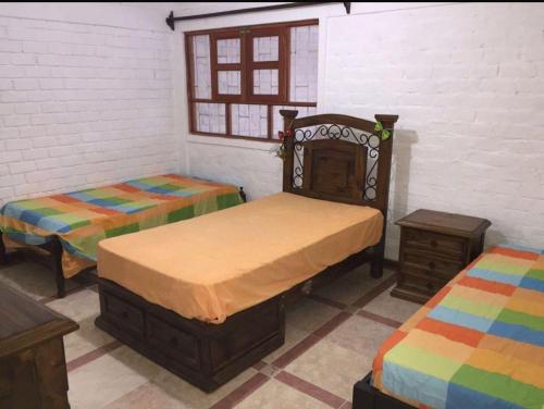 En eller flere senge i et værelse på Casa Colan Frente al Mar