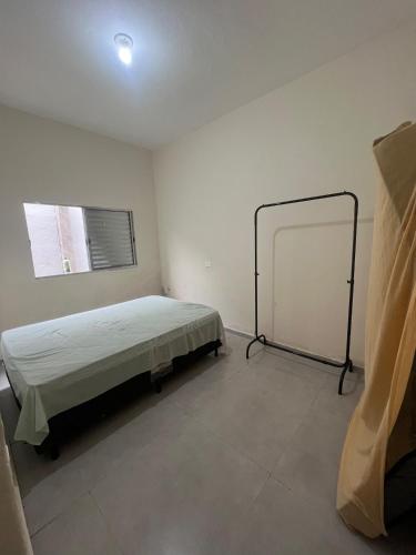 Ένα ή περισσότερα κρεβάτια σε δωμάτιο στο Casa São Vicente - 10 min from Praia Grande Ocean