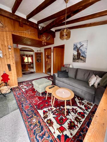 a living room with a couch and a table at Chalet in Vals in Vals