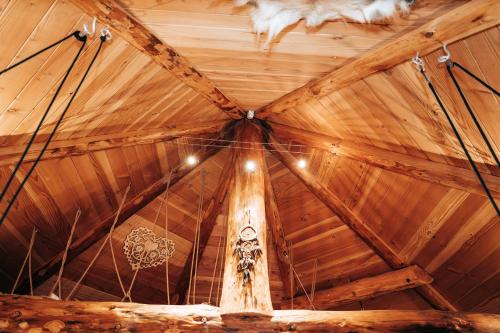 a ceiling of a wooden building with a cross at Les Cabanes Du Saleve in Collonges-sous-Salève