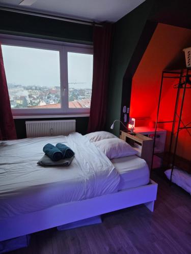 T2 Cosy spacieux Balneo Sauna Parking Noel في ستراسبورغ: غرفة نوم بسرير كبير مع ضوء احمر