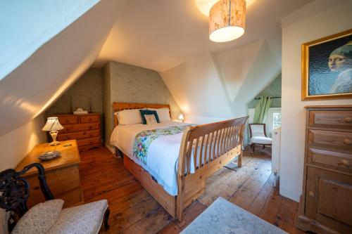 a bedroom with a bed and a wooden floor at The Old Rectory Framlingham in Framlingham