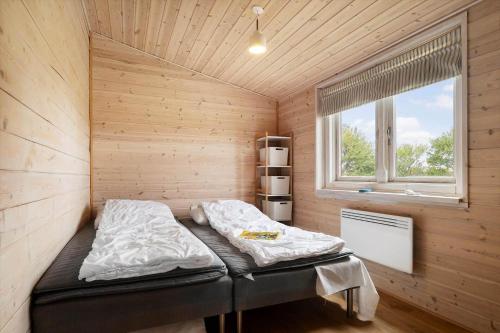 a bed in a small room with a window at 20158-Samso-Laerkevej-13 in Mårup