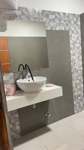 a bathroom with a sink and a mirror at Cerquita del Cielo in San Bernardino