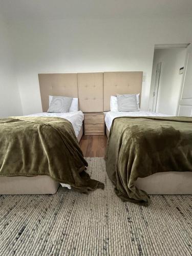 two beds sitting next to each other in a room at Serenity Green House near Constantia Winelands in Square Hill