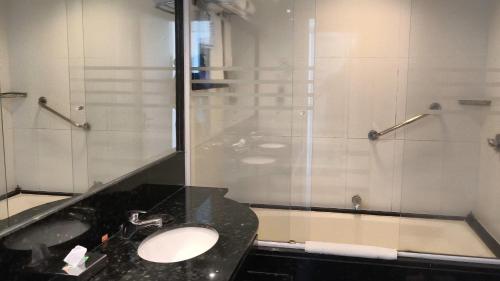 a bathroom with a sink and a shower at Wyndham Rio Barra in Rio de Janeiro