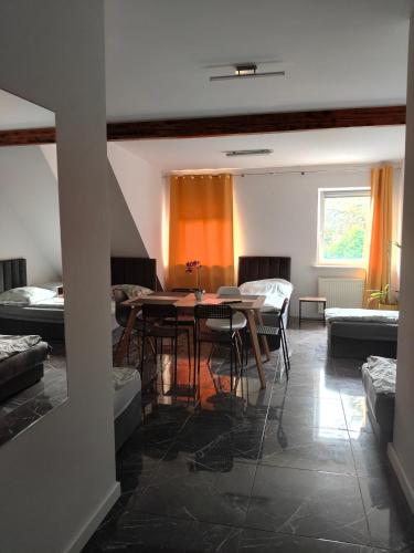 een kamer met een tafel, stoelen en een bank bij Pokoje wynajem Macierzysz in Mory