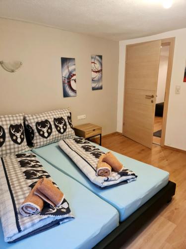 a bedroom with a bed with two towels on it at Apart Stefan Niederthai in Niederthai