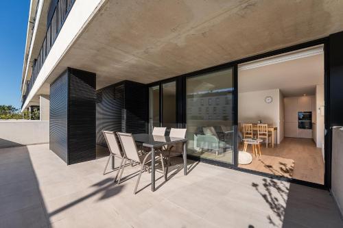 a balcony of a house with a table and chairs at GuestReady - Seaside oasis in private condo in Apúlia