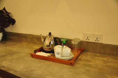 a tray with a tea kettle and cups on a counter at Green Villa Unawatuna in Unawatuna