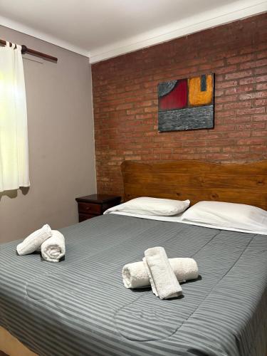 a bedroom with a bed with towels on it at Cabañas 4 Cascadas in San Rafael