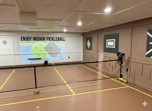 a tennis court with a net in a gym at Lux Spacious Cabin Hot Tub, Indoor Pickleball in Hocking Hills in Logan