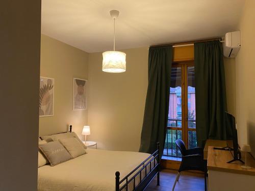 a bedroom with a bed and a window at Casa di Gea in Biella