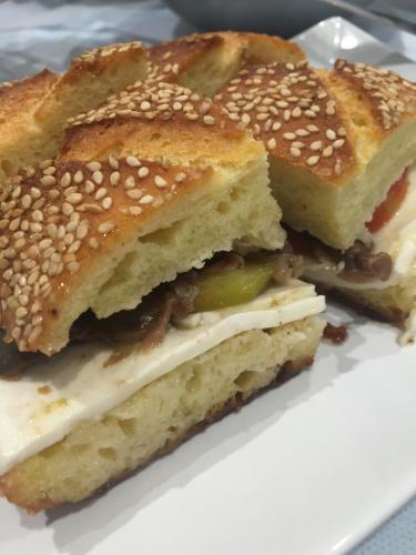 three sandwiches on a white plate on a table at Hotel Perla Gaia in San Vito lo Capo