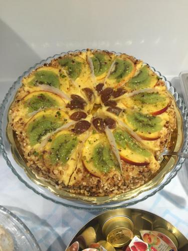 a pie on a glass plate on a table at Hotel Perla Gaia in San Vito lo Capo