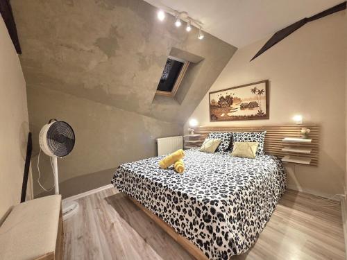 a bedroom with a leopard print bed in a room at Le Cosy Center in Thonon-les-Bains