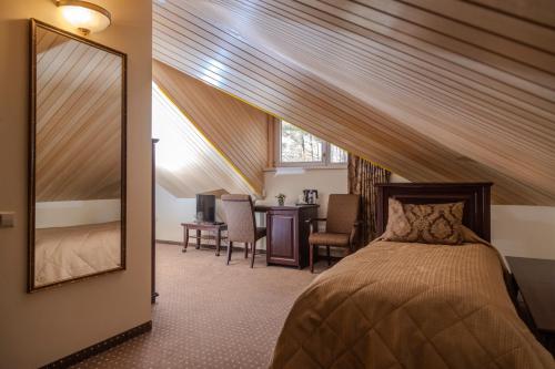 Ένα ή περισσότερα κρεβάτια σε δωμάτιο στο Pušynė