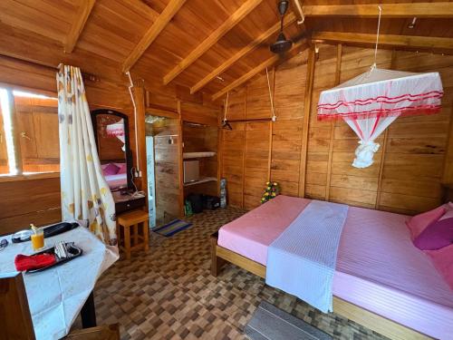 a bedroom with a bed in a wooden room at Wooden House Mirissa in Mirissa