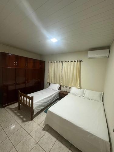 Ένα ή περισσότερα κρεβάτια σε δωμάτιο στο Casa Bom Clima