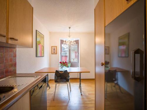 a kitchen with a table and a dining room at Central Bern Flat - Balcony & Bundeshaus View in Bern
