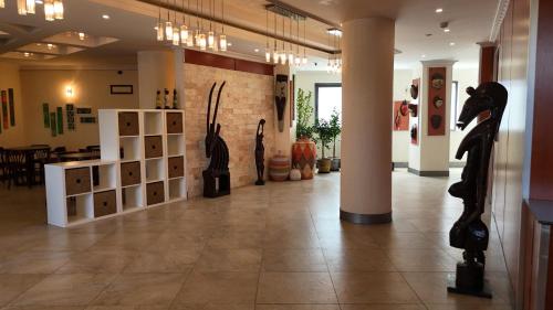 a lobby with sculptures on display in a building at Kora Hotel Suites in Addis Ababa