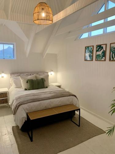 a bedroom with a large bed and a chandelier at Imhoff's Gift Sweet Escape in Imhoffʼs Gift