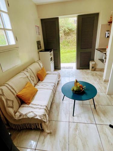 a living room with a couch and a table at L essenCiel in Saint-Claude