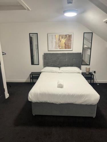 a bedroom with a large white bed in a room at Park Studios in Sunderland