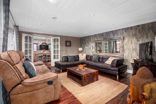 a living room with a couch and a table at The Old Bakehouse - Group Getaway in Llandysul