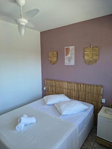 een slaapkamer met twee bedden met handdoeken erop bij Pousada Guarda do Embaú in Guarda do Embaú