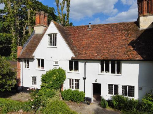 a white house with a red roof at The Old Rectory Framlingham in Framlingham