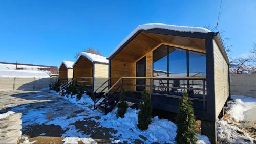a small building with snow on the ground at Aiwa Eco Hotel in Karakol