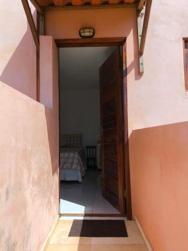 an open door to a bedroom with a bed in a room at Casa Mari Suites in Canoa Quebrada